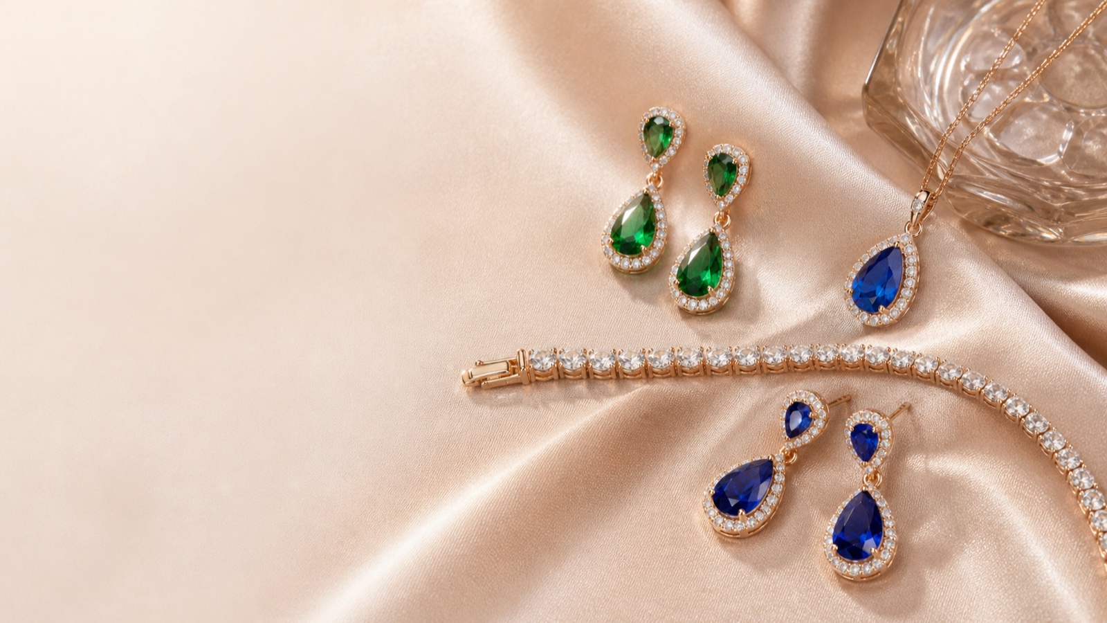 Colorful cubic zirconia earrings, pendant and tennis bracelet arranged on satin